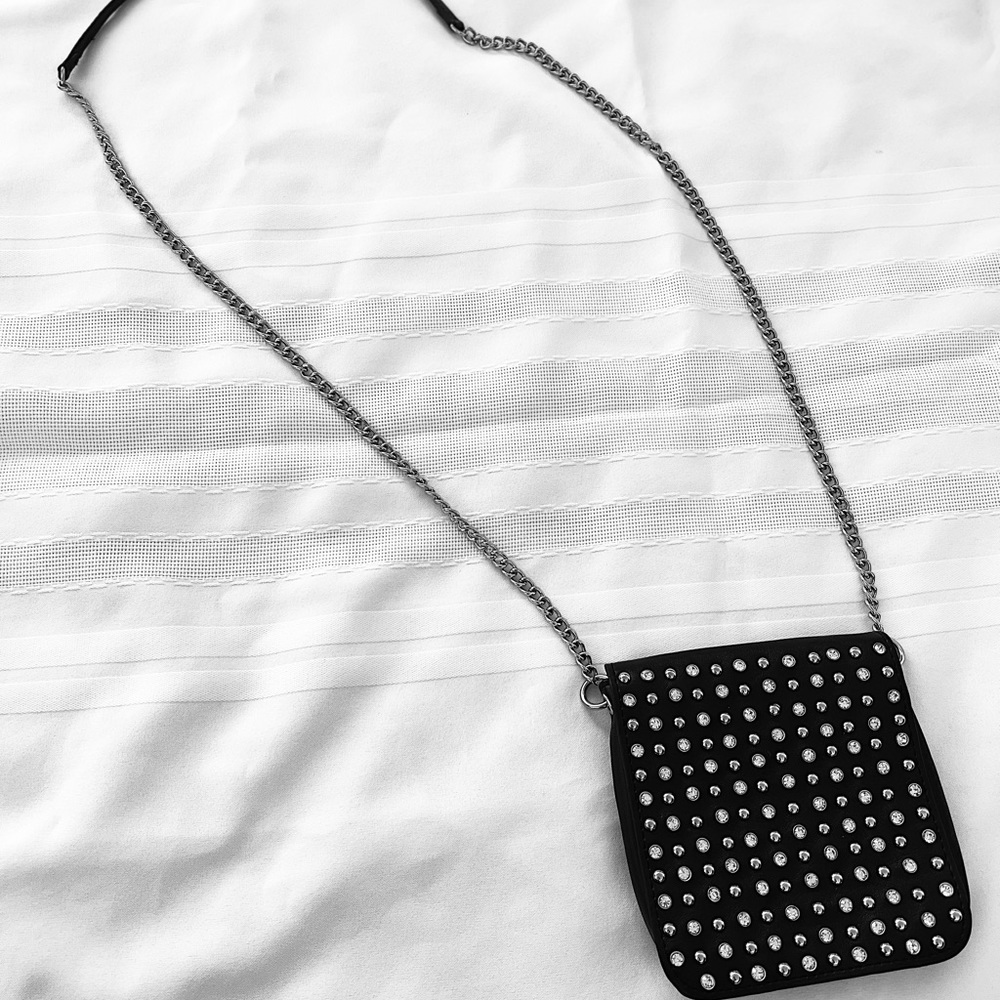 Small, black, rhinestone studded purse. Can be worn crossbody or on shoulder.